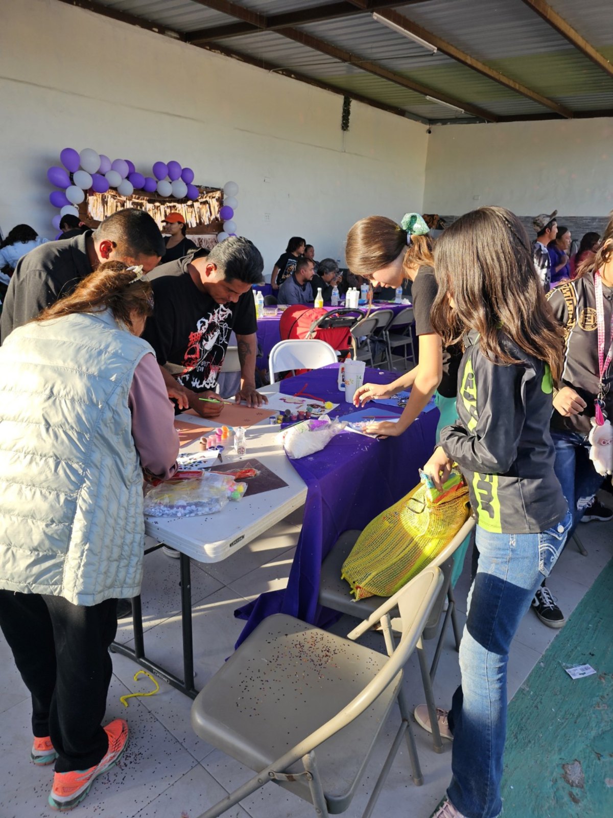 Community members around activity and vendor tables at HHF Bazaar