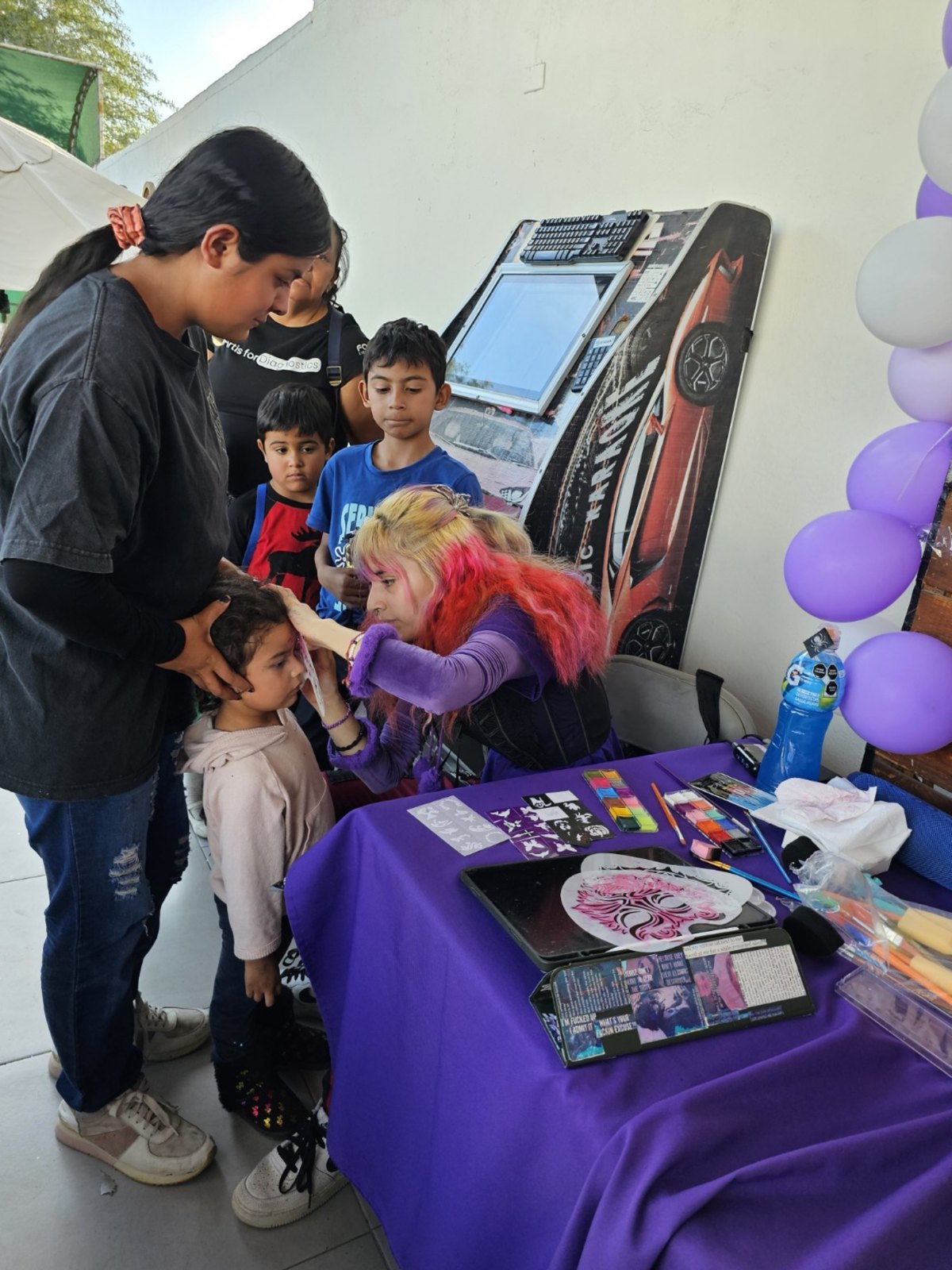 Face painting booth at a Happy Homes Foundation event